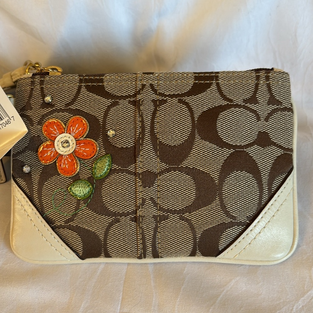 Coach Signature Collection features classic wristlet.